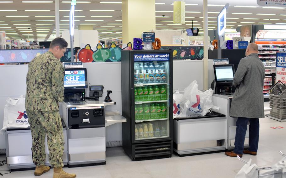 Customers use new self-checkout station inside the exchange at Yokota Air Base, Japan, Thursday, Oct. 27, 2022. 