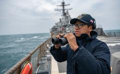 Seaman Xi Chan stands lookout on the destroyer USS Barry as it passes through the Taiwan Strait on April 23, 2020.