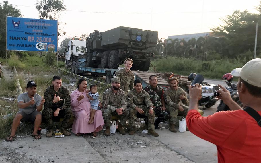 U.S. soldiers pose with Indonesian locals in front of their High Mobility Artillery Rocket System on the island of Sumatra, Tuesday, Aug. 9, 2022. 