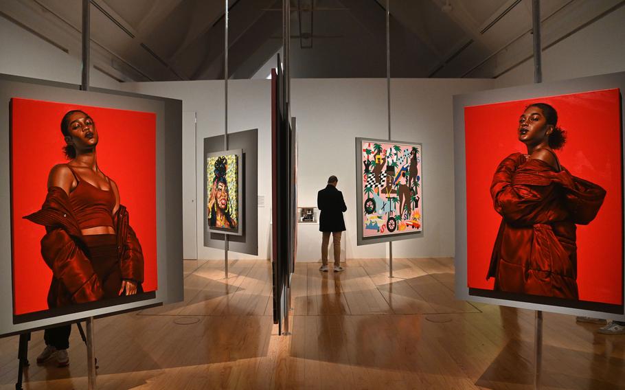 Inside the exhibit “The Culture: Hip Hop and Contemporary Art in the 21st Century” at the Schirn in Frankfurt. At left and right foreground are Monica Ikegwu’s oil on canvas works “Open/Closed,” from 2021. In the background at left is Megan Lewis’s “Fresh Squeezed Lemonade” from 2022 and at right, Nina Chanel Abney’s work “Untitled,” from the same year.