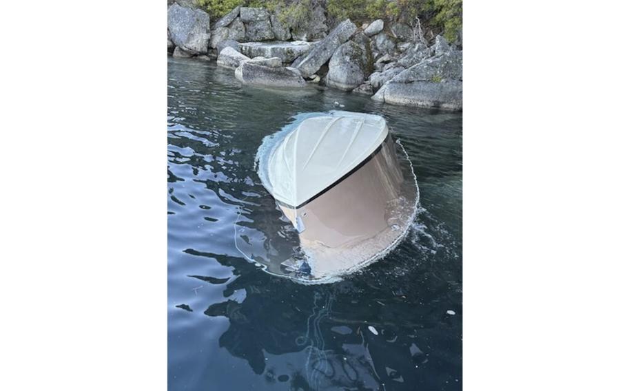 A capsized vessel floats in the water