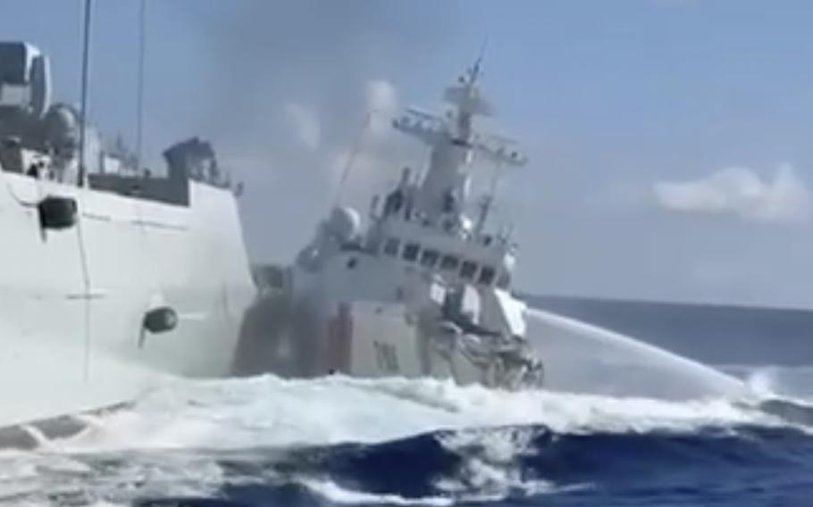 A video still of a coast guard ship with a damaged end idling in open water next to the hull of a naval vessel.