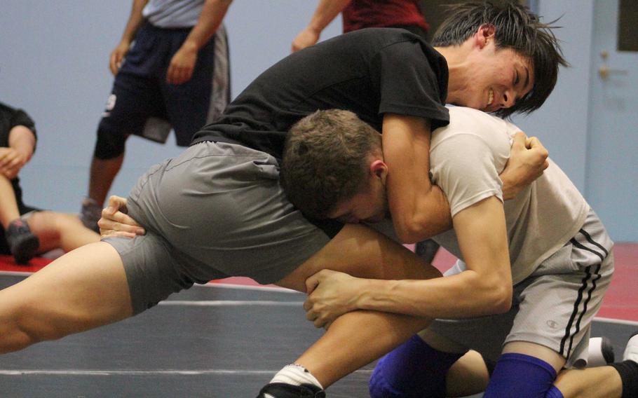 Senior John Shaver and sophomore Jacob Morton go through their paces during Matthew C. Perry wrestling practice.