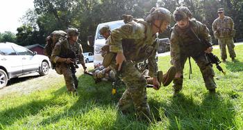 Security Force Assistance Brigade soldiers — known as “advisors” — help a soldier with a simulated injury during a pre-deployment training exercise Aug. 23, 2023, at Muscatatuck Training Center in Indiana. 