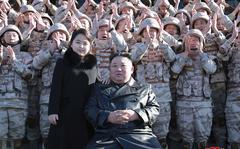 This undated photo provided on Nov. 27, 2022, by the North Korean government shows North Korean leader Kim Jong Un, center right, and his daughter, center left, with soldiers, pose for a photo,  following the launch of what it says a Hwasong-17 intercontinental ballistic missile, at an unidentified location in North Korea. 