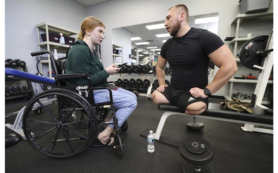 Iryna talks with her fiancee Mykhalo Varvarych at Prosthetic and Orthotic Associates in Orlando, on Thursday, February 23, 2023. Sgt. Varvarych, a commander with Ukraine’s 80th Airborne Assault Brigade, lost his legs from a Russian landmine. 