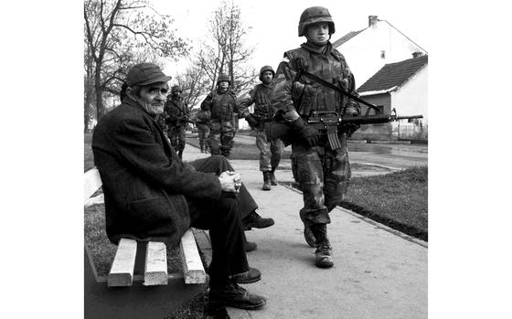 Brcko, Bosnia and Herzegovina, February, 1997: American soldiers walk past a Brcko resident during a routine patrol through the streets of the northern Bosnian city.

Looking for Stars and Stripes’ historic coverage? Subscribe to Stars and Stripes’ historic newspaper archive! We have digitized our 1948-1999 European and Pacific editions, as well as several of our WWII editions and made them available online through https://starsandstripes.newspaperarchive.com/

META TAGS: U.S. Army; Yugoslavia; Bosnia and Herzegovina; IFOR; Operation Joint Endeavour