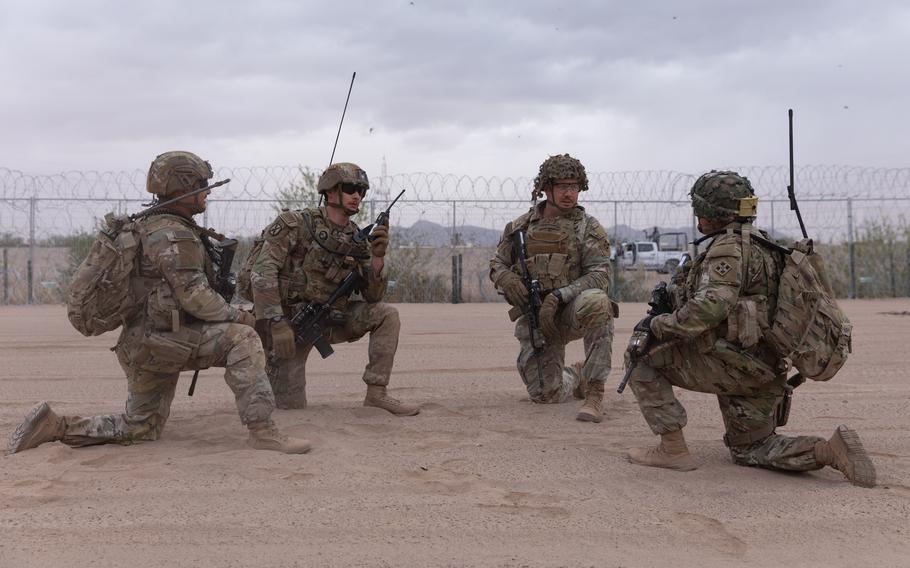 Soldiers kneel during stop during a southern border patrol.