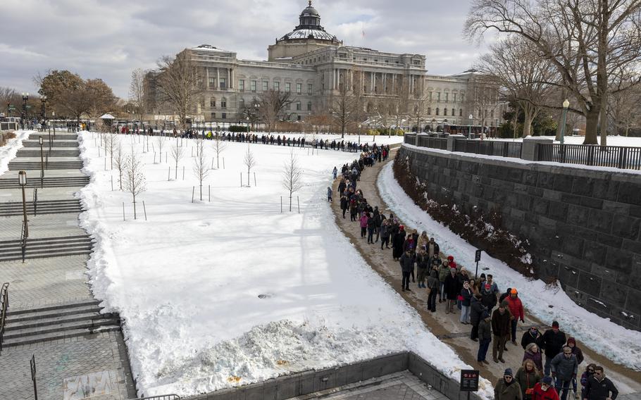 People form a line outside the Capitol.