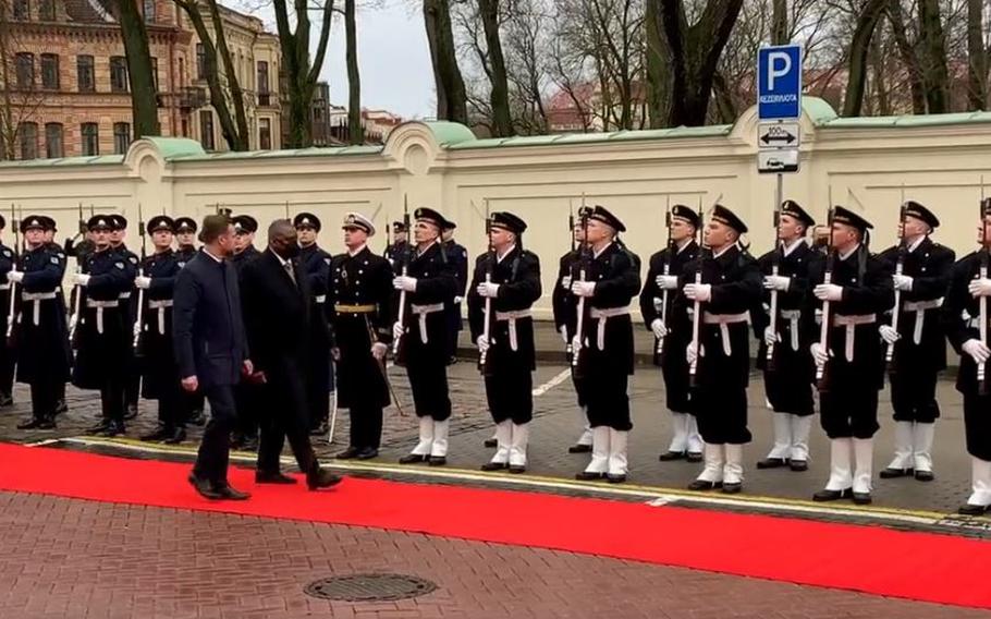 Lithuanian Acting Defense Minister Garbielius Landsbergis  and U.S. Defense Secretary Lloyd Austin review troops following talks in Vilnius, Lithuania,  Feb. 19, 2022.