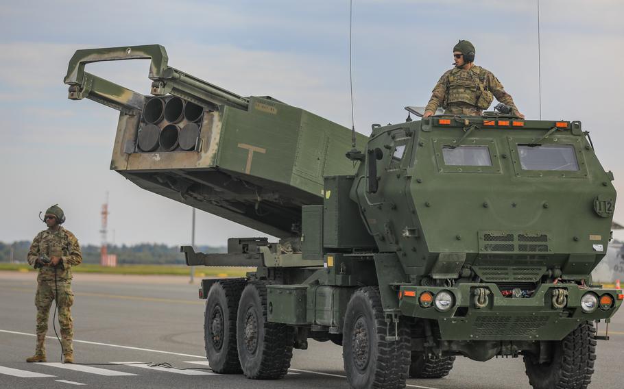 Spc. Jamil P. Samuel, left, and Pfc. Richard S. Gammon, both High Mobility Artillery Rocket System crew members assigned to the 18th Field Artillery Brigade, prepare their system during a Latvian-led exercise at Liepaja, Latvia, Sept. 26, 2022. The State Department on Tuesday greenlit delivery of additional HIMARS systems to Poland.
