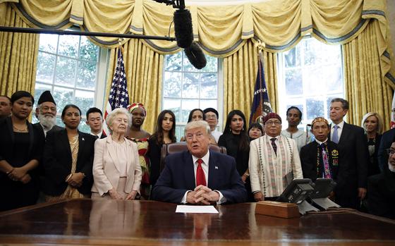 FILE - President Donald Trump speaks as he meets with survivors of religious persecution, including Hkalam Samson, standing on the first row, second from right, in the Oval Office of the White House on Wednesday, July 17, 2019, in Washington. Hkalam Samson, prominent Christian church leader and human rights advocate from Myanmar’s Kachin ethnic minority, was detained by the authorities just hours after he was released from prison under an amnesty by the military government, a relative, a colleague and local media said Thursday, April 18, 2024. (AP Photo/Alex Brandon, File)