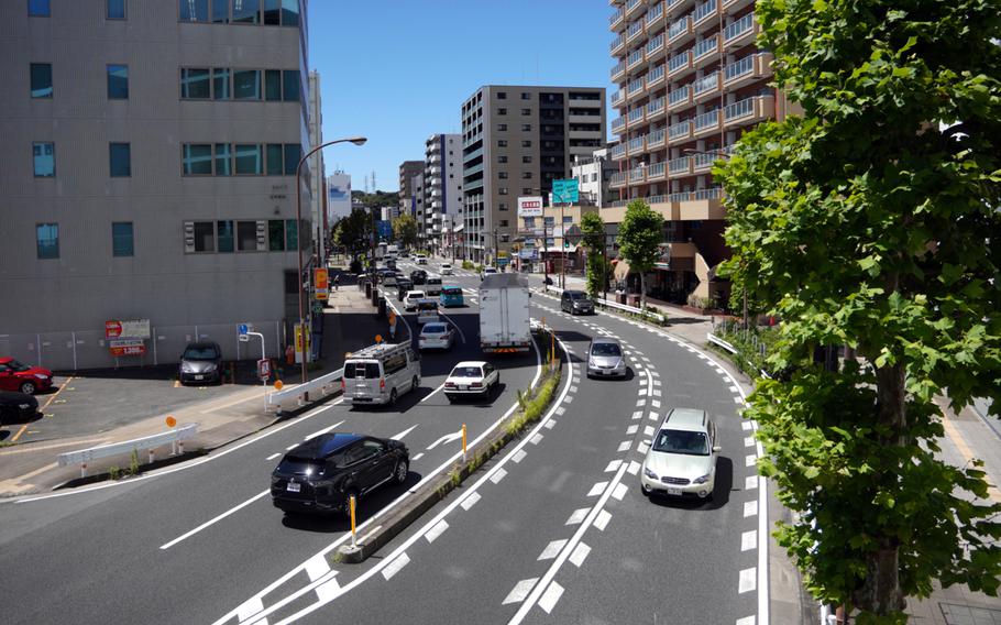 Vechicles travel on Route 16 near Yokosuka Naval Base, Japan, Friday, Aug. 25, 2023.