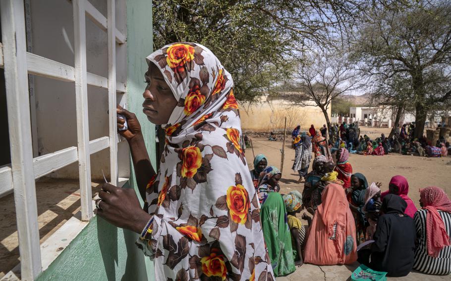 A woman waits to receive medication at a mobile clinic at a damaged hospital in Sirba. The French nonprofit Première Urgence Internationale runs the clinic, and most of its patients are sheltering at the hospital, nearby schools or other administrative buildings. It is the only health-care service in the Sirba locality and carries out over 100 consultations each day.