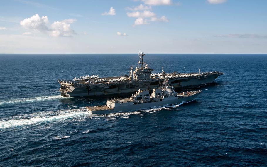 The destroyer USS Gravely sails alongside the aircraft carrier USS Harry S. Truman during a replenishment-at-sea exercise, Jan. 22, 2022 in the Mediterranean Sea.