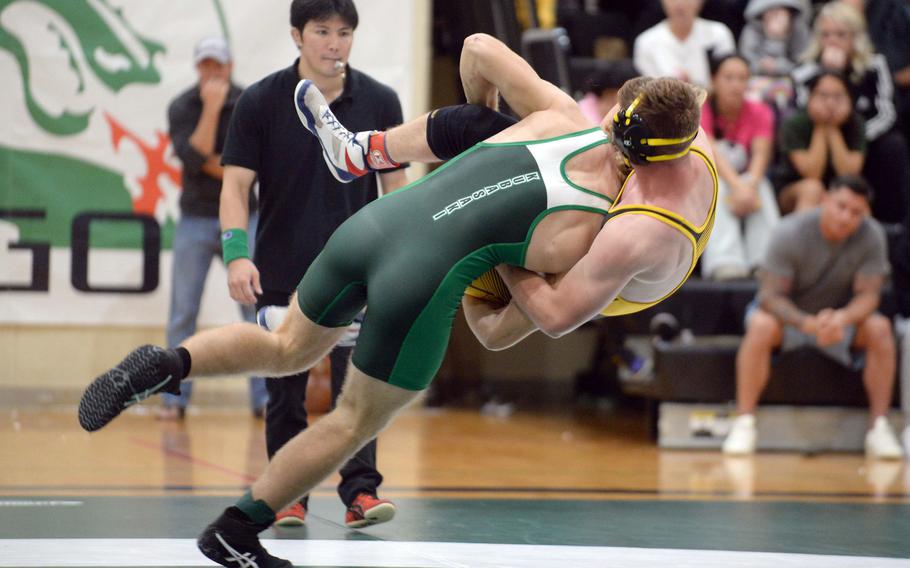 Kubasaki 172-pounder Kaiser Armour sends Kadena's Ryder Livingston airborne during Wednesday's Okinawa wrestling dual meet. Armour pinned Livingston in 1 minuyte, 6 seconds, but the Panthers won the meet 35-26 to go 2-0 on the season.