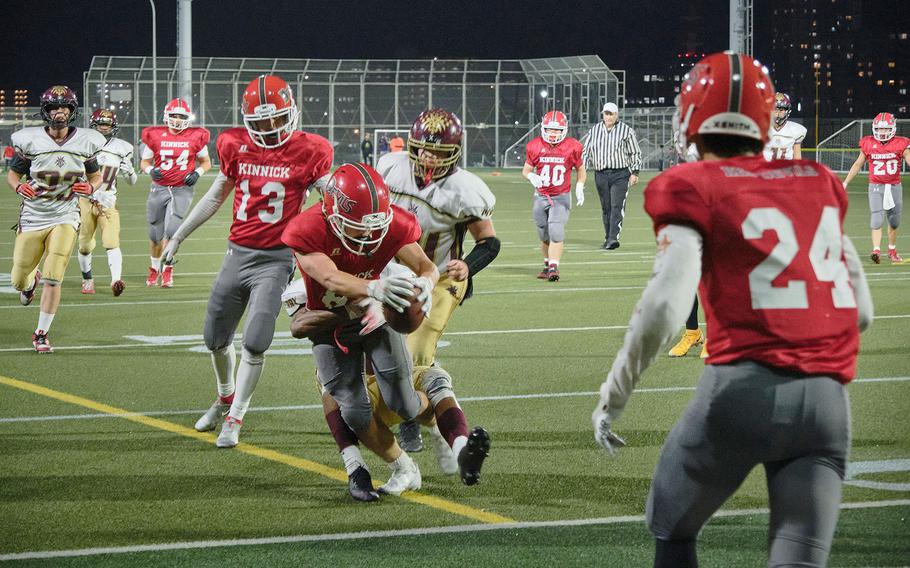 Nile C. Kinnick's Kaito Demoss is tackled after catching a pass during a game against Matthew C. Perry on Friday, Sept. 17, 2021.