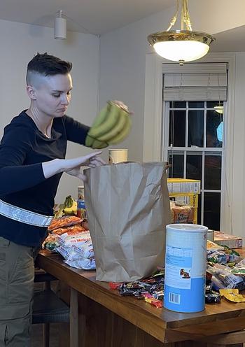 Military spouses Ashley Gutermuth, pictured here bagging up groceries, and Heather Campbell are helping to feed military families experiencing food insecurity by buying groceries and cooking meals. The women hope their efforts inspire others to help military families get the food they need.