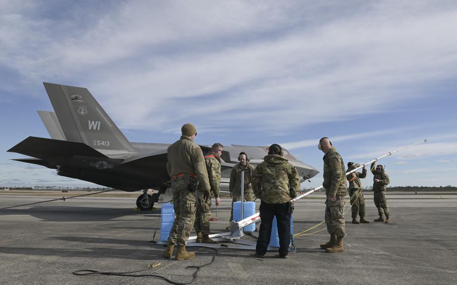 Aircraft maintenance specialists with the Wisconsin Air National Guard’s 115th Fighter Wing raise a grounding rod during a Weapons System Evaluation Program exercise Feb. 13, 2024, at Tyndall Air Force Base, Fla. 