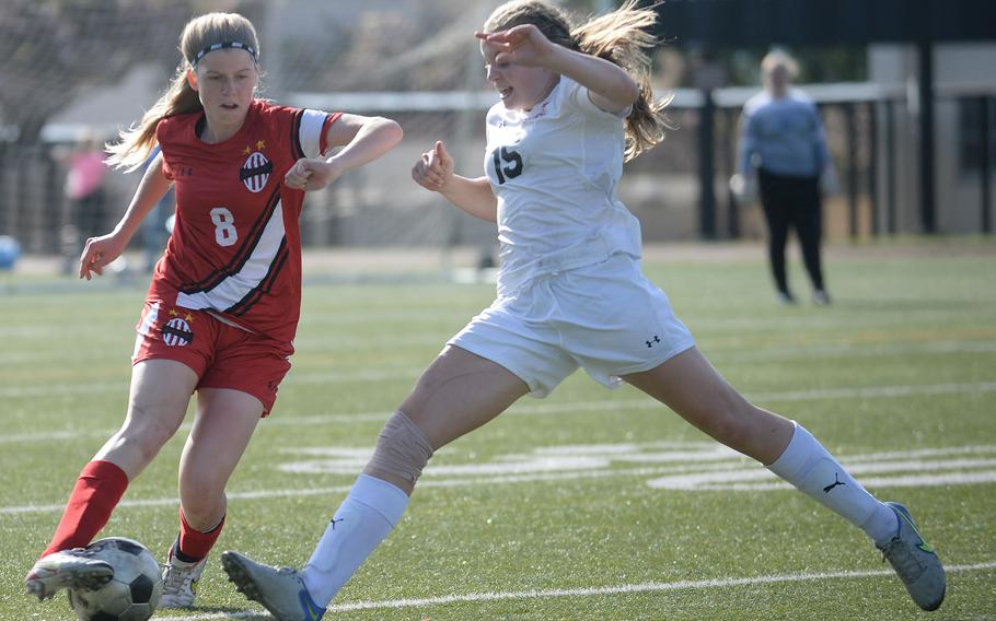 E.J. King's Madylyn O'Neill chases down Nile C. Kinnick's Bree Withers with the ball during Friday's All-DODEA-Japan soccer tournament quarterfinal. The Red Devils won 3-1.