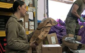 Airman 1st Class Veronica Westbrook processes packages at Aviano Air Base, Italy, Nov. 12, 2024. With White House-directed tariffs on the horizon, confusion over whether parcels from Defense Department bases overseas can be mailed duty-free to the U.S. prompted reassurances from military mail officials in Europe.