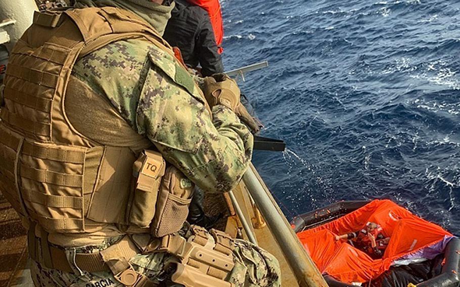 Petty Officer 2nd Class Michael Garcia, aboard the Military Sealift Command fleet replenishment oiler USNS Patuxent, relays information on a radio during rescue operations for the crew members of the commercial vessel Falcon Line, which sank in the Gulf of Aden, June 8, 2021.