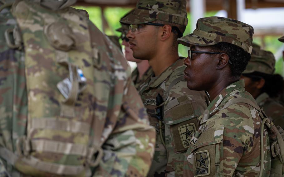 A group of soldiers listening to instructions.