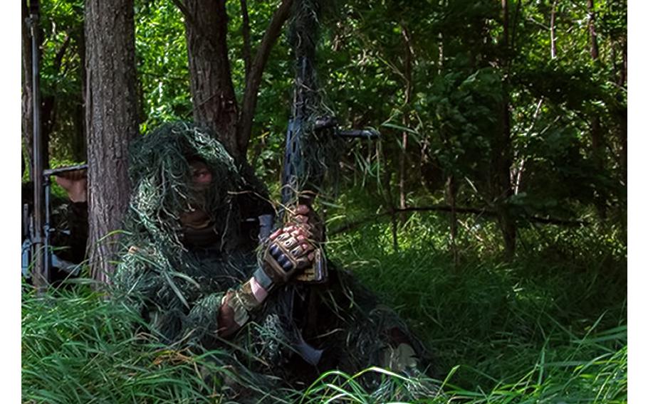 A Russian sniper looks toward Ukrainian positions at the Zapad group of Russian troops at an undisclosed location in Ukraine, according to a Russain release on Aug. 10, 2023.
