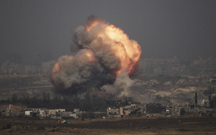 A plume of smoke rises into the air, as seen from a distance.