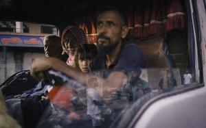 Bedouin residents of Sweida join an evacuation convoy organized by the Syrian Arab Red Crescent, while Druze militants secure the area. MUST CREDIT: Lorenzo Tugnoli/For The Washington Post