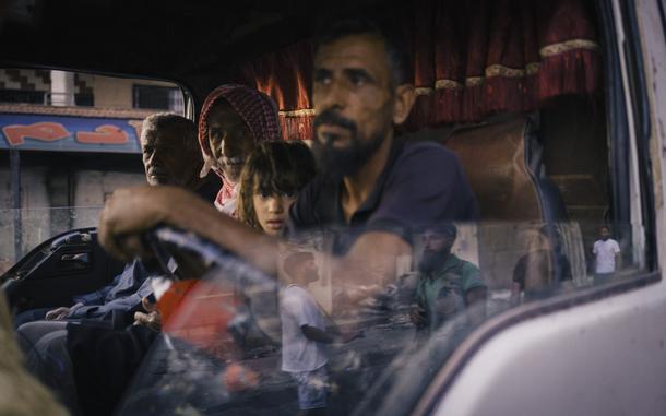 Bedouin residents of Sweida join an evacuation convoy organized by the Syrian Arab Red Crescent, while Druze militants secure the area. MUST CREDIT: Lorenzo Tugnoli/For The Washington Post