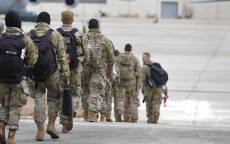 Paratroopers from the 18th Airborne Corps and 82nd Airborne Division board planes at Fort Bragg, N.C., on Feb. 3, 2022, to fly to Europe in support of NATO allies. The first troops landed in Poland Feb. 4.