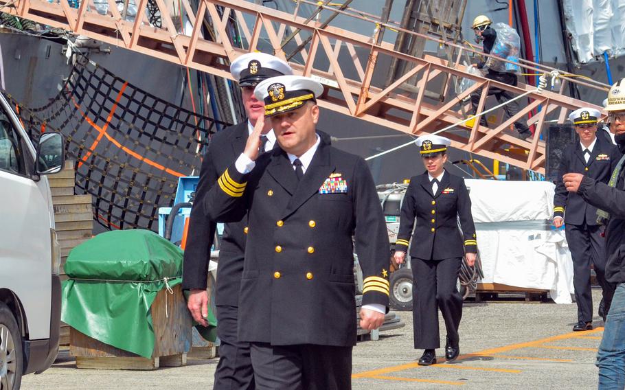 USS McCampbell skipper Cmdr. James Pierce III salutes upon the guided-missile destroyer’s return to Yokosuka Naval Base, Japan, on March 2, 2024.