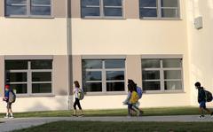 Students walk to class on the first day of school at Vogelweh Elementary School, Germany, Aug. 24, 2020. Sierra Eberhardt, a teacher at the U.S. base school, was recently forced to pay about $150,000 in German income tax penalties despite a military treaty designed to put her pay off limits. 