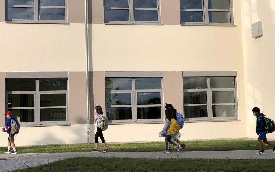 Students walk to class on the first day of school at Vogelweh Elementary School, Germany, Aug. 24, 2020. Sierra Eberhardt, a teacher at the U.S. base school, has been forced to pay about $150,000 in German income tax penalties despite a military treaty designed to put her pay off limits. 