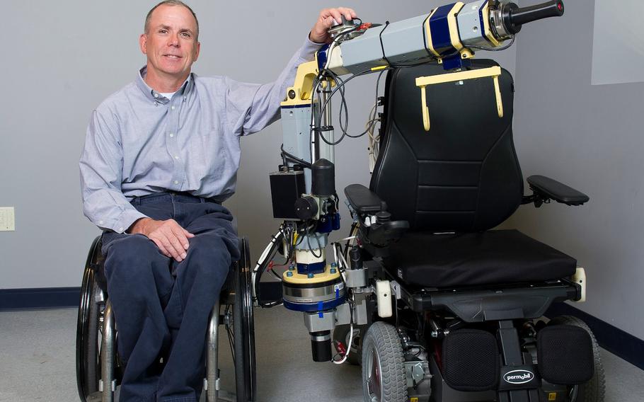 Rory A. Cooper, a disabled Army veteran, has spent most of his adult life trying to make life easier for people with disabilities. To fulfill that mission, he proposed and created the University of Pittsburgh’s Human Engineering Research Laboratories, which he has headed since 1994. Pictured is Cooper with his team’s Strong Arm invention, a robot that assists caregivers with transferring people between wheelchairs and beds.