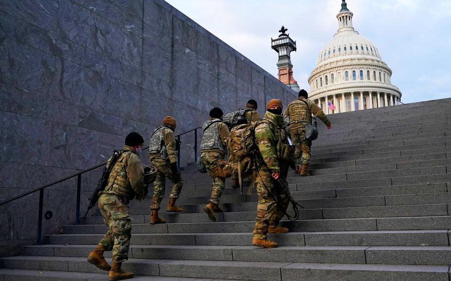 National Guard members take a staircase toward the U.S. Capitol building before a rehearsal for President-elect Joe Biden's Presidential Inauguration in Washington, Jan. 18, 2021.