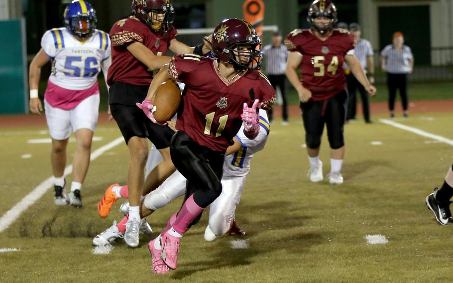 Kameron Ramos runs with the football.