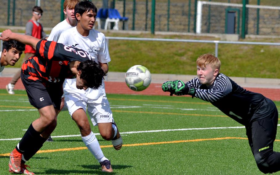Naples goalie Mayo Urban and AOSR’s Zane El Kilany go for the ball after a corner kick in the Division II final at the DODEA-Europe soccer championships in Ramstein, Germany, May 18, 2023. American Overseas School of Rome took the title with a 5-1 over the Wildcats in an all-Italy final.