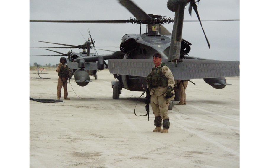 A U.S. soldier stands by a UH-60 Black Hawk helicopter before taking off from Khost, Afghanistan, Aug. 14, 2002. For the first time, U.S. soldiers have begun aerial vehicle checks near the Pakistan border, an area where Taliban and al-Qaida members are believed to have been regrouping.