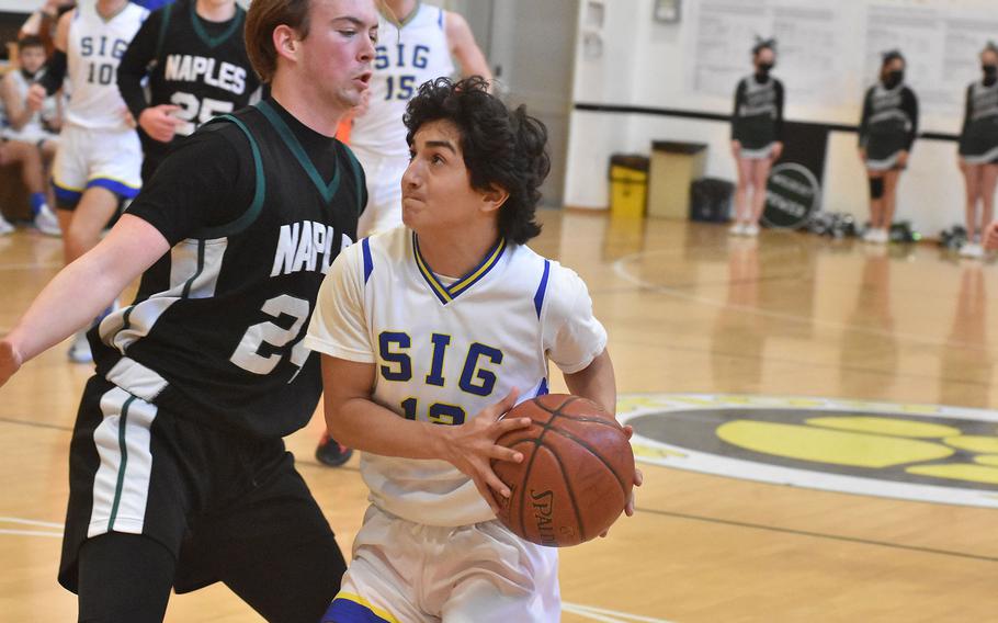Sigonella's Alessandro Montero looks to score while guarded by Naples' Corbin Gustafson on Thursday, March 3, 2022 at the DODEA-Europe Division II basketball championships.