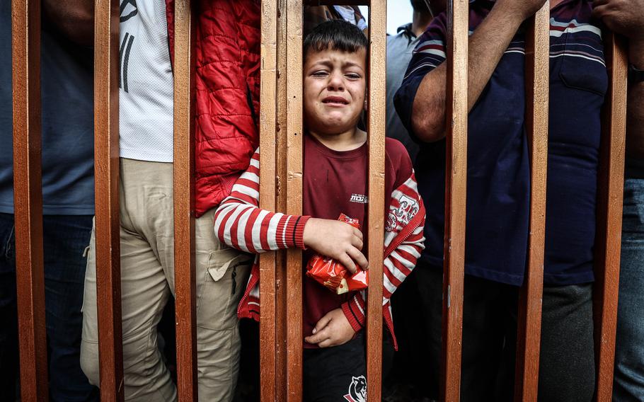 People gather outside the morgue at a hospital in Khan Younis, in the Gaza Strip, before funerals are held for Palestinian casualties.