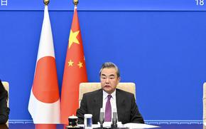 In this photo released by Xinhua News Agency, Chinese Foreign Minister Wang Yi speaks during meeting with Japanese Foreign Minister Yoshimasa Hayashi, unseen via video link from Beijing on Wednesday, May 18, 2022. Chinese Foreign Minister Wang Yi criticized on Wednesday what he called negative moves by Washington and Tokyo against Beijing ahead of a meeting in Tokyo next week of the leaders of the U.S., Japan, Australia and India. (Yin Bogu/Xinhua via AP)