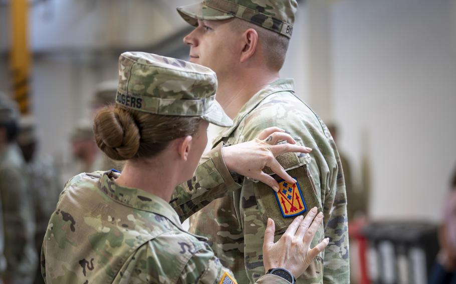 A U.S. soldier assigned to 5th Battalion, 4th Air Defense Artillery receives his 52nd Air Defense Artillery Brigade shoulder patch during a ceremony Aug. 3, 2023, in Ansbach, Germany. A new air defense unit under the brigade, the 1st Battalion, 57th Air Defense Artillery Regiment, will be based out of Ansbach, with one of its batteries operating in Vicenza, Italy.