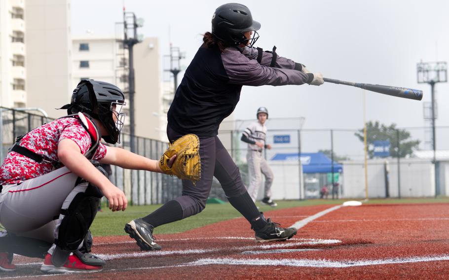 Zama’s Kierstyn Aumua smacks a two-run single for the Trojans against E.J. King during Thursday’s All-DODEA Japan baseball game. The Cobras rallied to win the game 4-3 in eight innings.