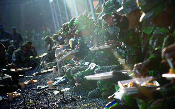 Pohakuloa Training Area, Hawaii, July 15, 2018: Indonesian Marines enjoy hot chow during the Rim of Pacific exercise.

Read the article and check out more photos from the exercise here. https://www.stripes.com/news/marines-wrap-up-big-island-phase-of-multinational-rimpac-drills-1.538616

META TAGS: exercise; multinational amphibious force; RIMPAC; Rim of Pacific; U.S. Marine Corps; USMC; 1st Battalion, 3rd Marine Regiment; Sri Lankan Marine Corps; Task Force 176 