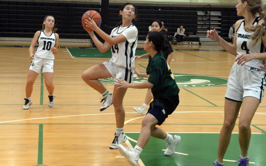 Kubasaki's Jessica Blackston shoots against a Koza defender during Tuesday's Okinawa girls basketball game. Koza won 57-37.