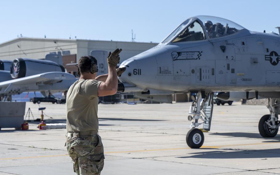 An airman points to an aircraft