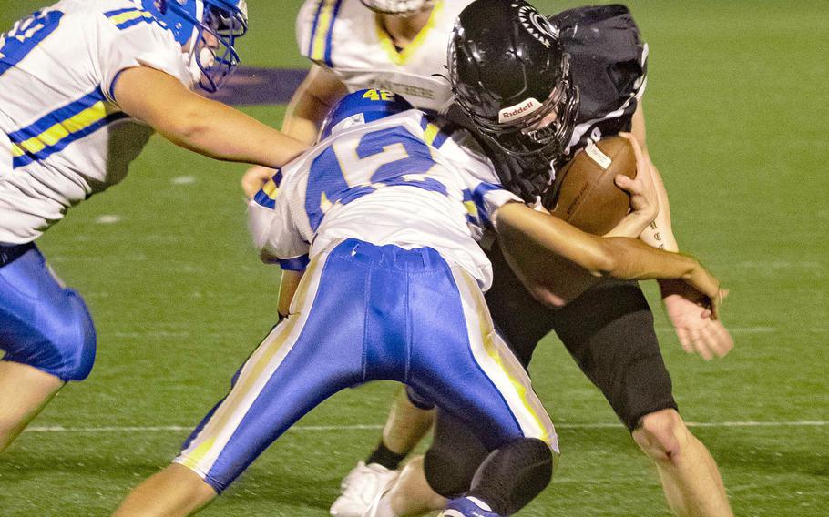 Zama quarterback Dominic Peruccio gets wrapped up by Yokota’s Damian Abrams.