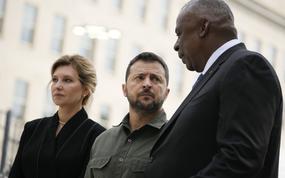 FILE - Secretary of Defense Lloyd Austin, speaks with Ukrainian President Volodymyr Zelenskyy during a wreath laying ceremony at the 9/11 Pentagon Memorial, Sept. 21, 2023, in Washington, as first lady of Ukraine, Olena Zelenska, looks on. The Pentagon is warning Congress that it is running low on funding to replace weapons the U.S. has sent to Ukraine and has already been forced to slow down restocking some troops. The warning from the Pentagon comptroller came in a letter sent to congressional leaders and was obtained by The Associated Press.  (AP Photo/Andrew Harnik, File)